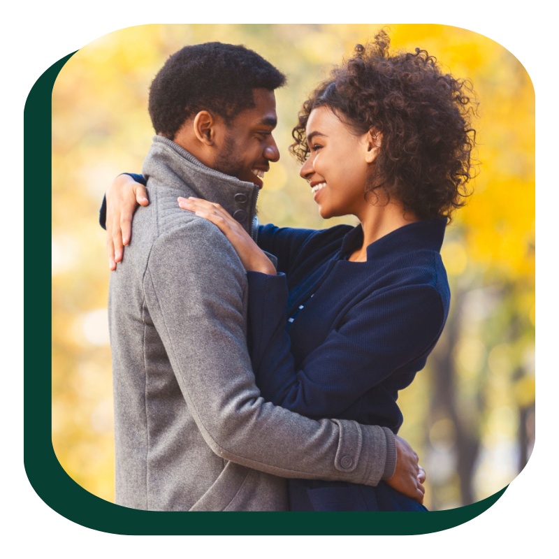 happy couple hug - green background